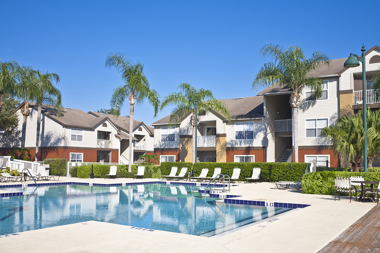 Condominium complex in the tropics with swimming pool, palmj trees and lush tropical foliate.